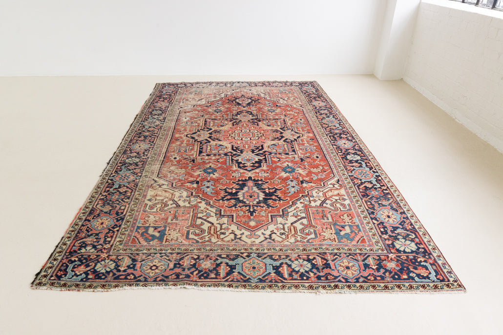 This is a handmade antique Heriz rug woven in Persia. The Heriz region is known for producing some of the most ornate Persian carpet, often known for their mesmerising and intricate repeating patterns.