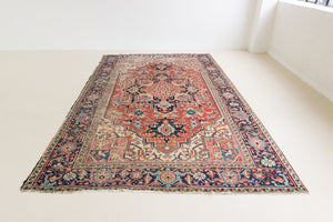 This is a handmade antique Heriz rug woven in Persia. The Heriz region is known for producing some of the most ornate Persian carpet, often known for their mesmerising and intricate repeating patterns.