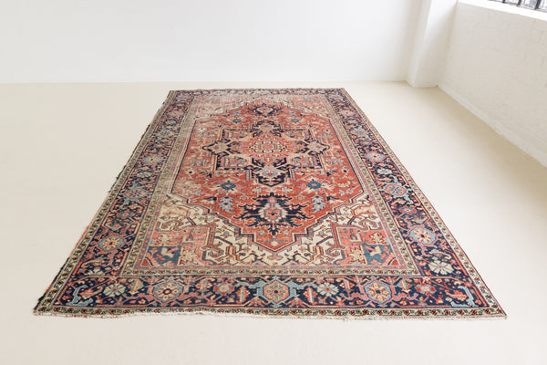 This is a handmade antique Heriz rug woven in Persia. The Heriz region is known for producing some of the most ornate Persian carpet, often known for their mesmerising and intricate repeating patterns.