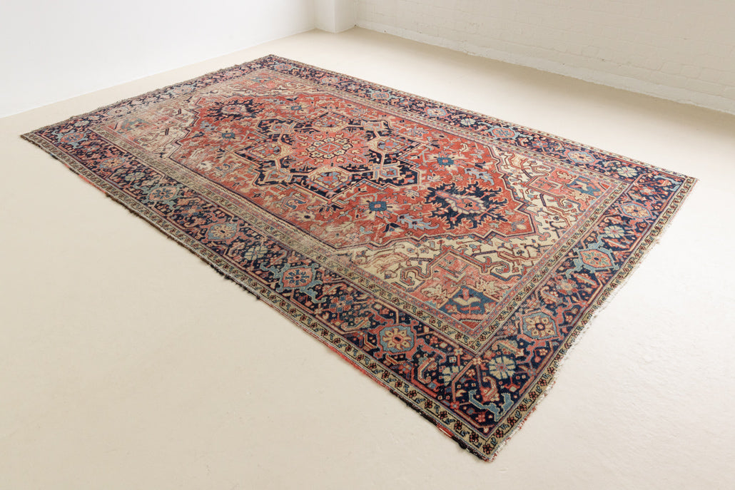 This is a handmade antique Heriz rug woven in Persia. The Heriz region is known for producing some of the most ornate Persian carpet, often known for their mesmerising and intricate repeating patterns.