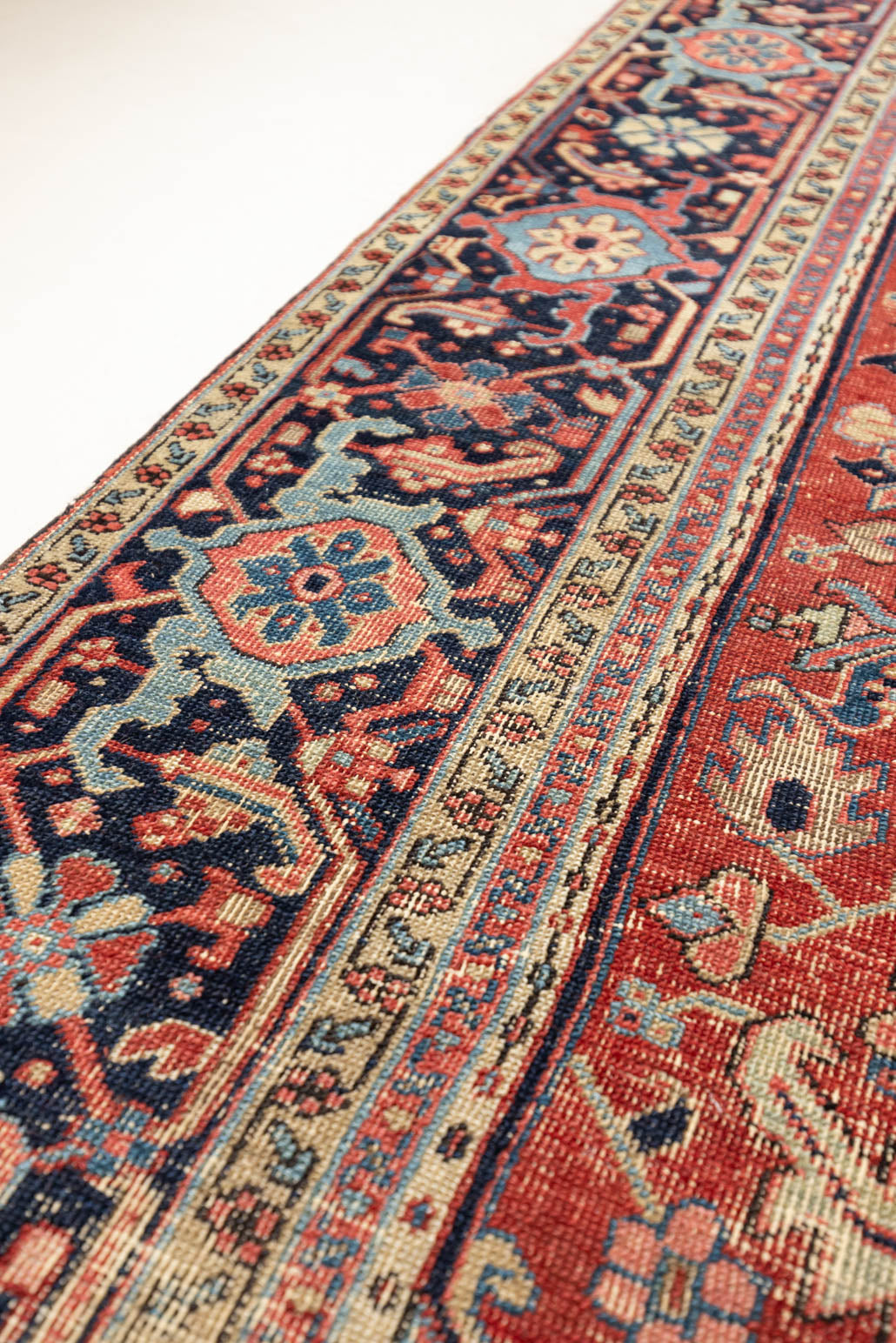 This is a handmade antique Heriz rug woven in Persia. The Heriz region is known for producing some of the most ornate Persian carpet, often known for their mesmerising and intricate repeating patterns.