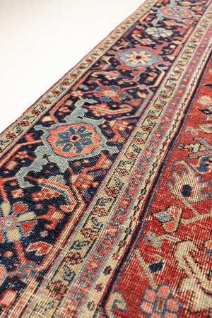 This is a handmade antique Heriz rug woven in Persia. The Heriz region is known for producing some of the most ornate Persian carpet, often known for their mesmerising and intricate repeating patterns.