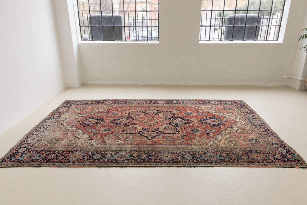 This is a handmade antique Heriz rug woven in Persia. The Heriz region is known for producing some of the most ornate Persian carpet, often known for their mesmerising and intricate repeating patterns.
