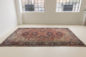 This is a handmade antique Heriz rug woven in Persia. The Heriz region is known for producing some of the most ornate Persian carpet, often known for their mesmerising and intricate repeating patterns.