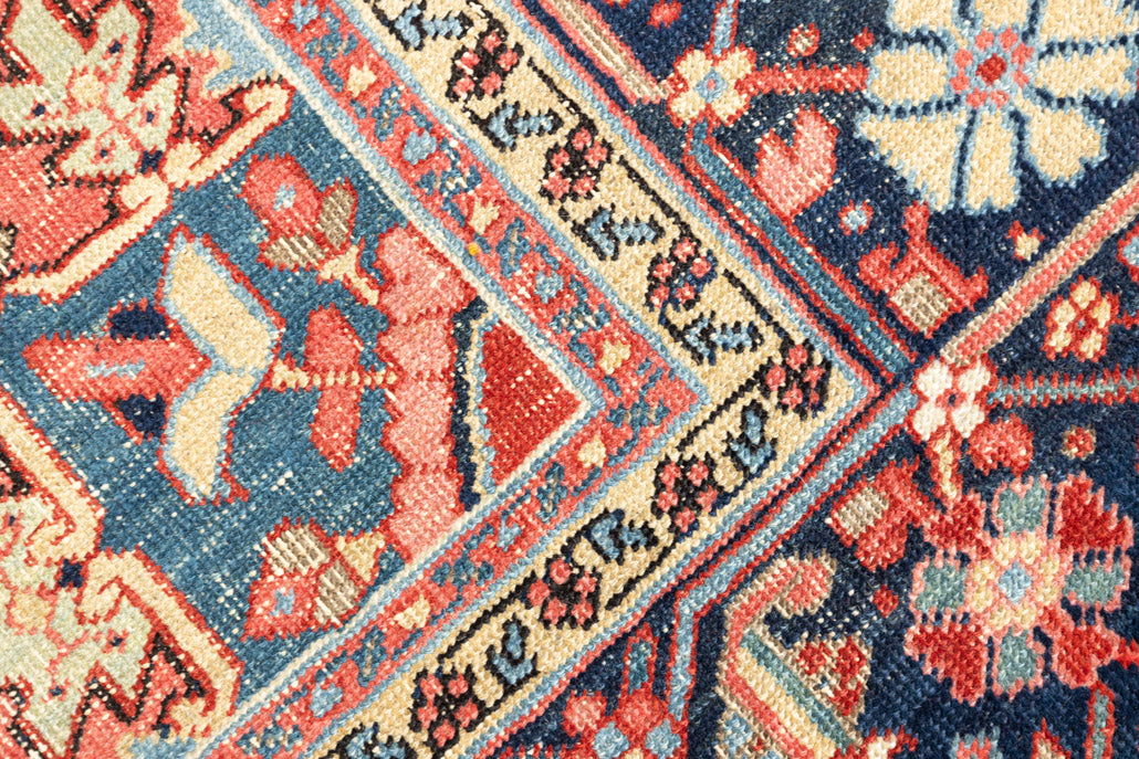 This is a handmade antique Heriz rug woven in Persia. The Heriz region is known for producing some of the most ornate Persian carpet, often known for their mesmerising and intricate repeating patterns.