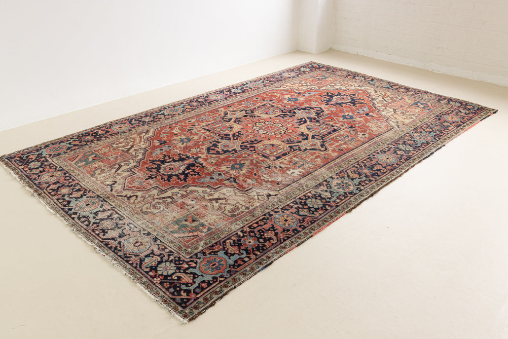 This is a handmade antique Heriz rug woven in Persia. The Heriz region is known for producing some of the most ornate Persian carpet, often known for their mesmerising and intricate repeating patterns.