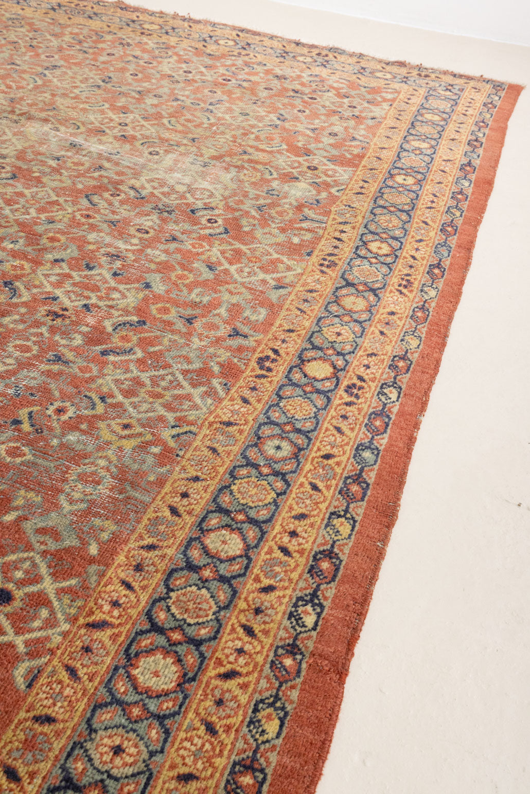 This is a handmade antique Mahal rug woven in Persia. The Mahal region is known for producing some of the most ornate Persian carpet, often known for their mesmerising and intricate repeating patterns.