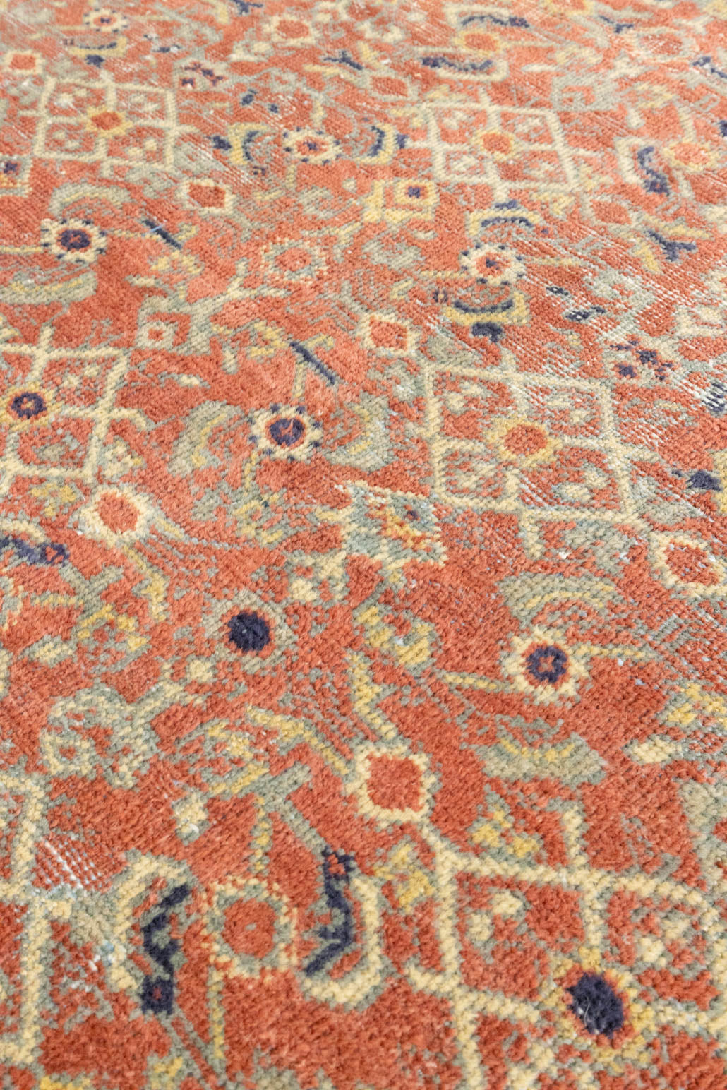 This is a handmade antique Mahal rug woven in Persia. The Mahal region is known for producing some of the most ornate Persian carpet, often known for their mesmerising and intricate repeating patterns.