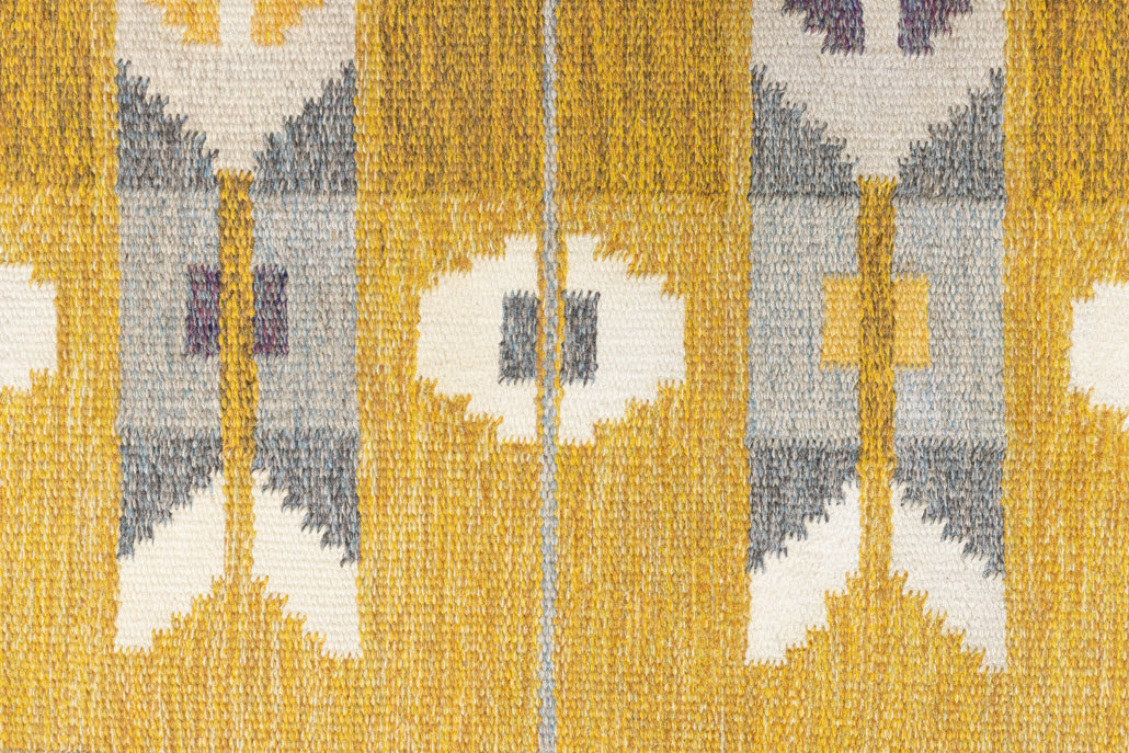 Eliza is a röllakan rug handwoven by textile designer Ingegerd Silow. Featuring a yellow, white and grey pattern