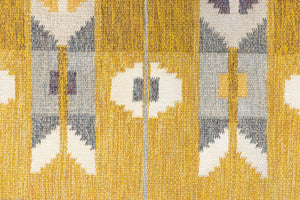 Eliza is a röllakan rug handwoven by textile designer Ingegerd Silow. Featuring a yellow, white and grey pattern