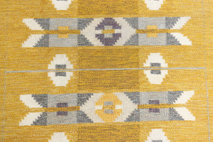 Eliza is a röllakan rug handwoven by textile designer Ingegerd Silow. Featuring a yellow, white and grey pattern