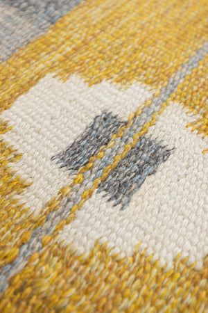 Eliza is a röllakan rug handwoven by textile designer Ingegerd Silow. Featuring a yellow, white and grey pattern