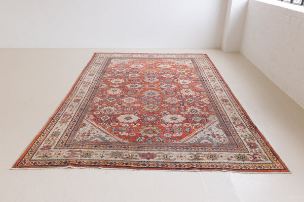 This a Vintage Persian Rug from Mahal in Persia. This hand woven Carpet features a lovely red ground with an all over design.