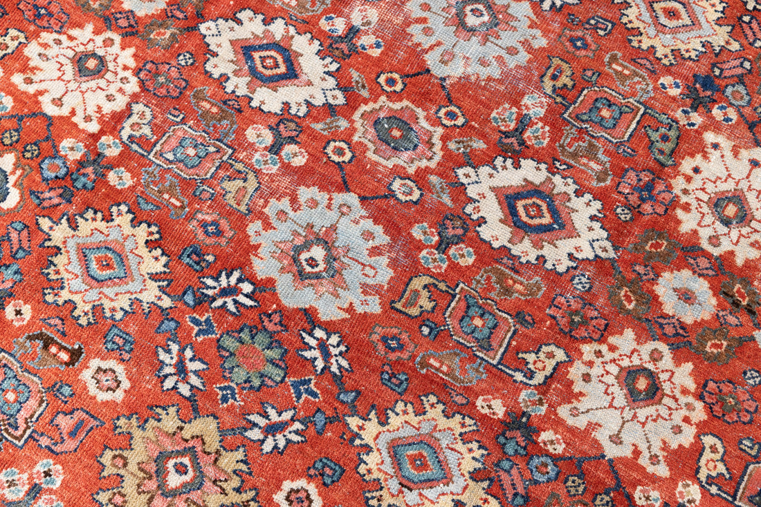This a Vintage Persian Rug from Mahal in Persia. This hand woven Carpet features a lovely red ground with an all over design.