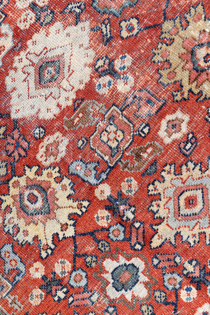 This a Vintage Persian Rug from Mahal in Persia. This hand woven Carpet features a lovely red ground with an all over design.