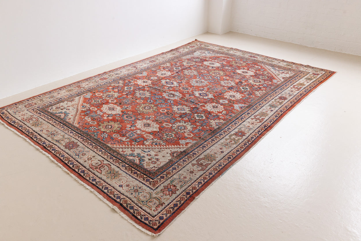 This a Vintage Persian Rug from Mahal in Persia. This hand woven Carpet features a lovely red ground with an all over design.