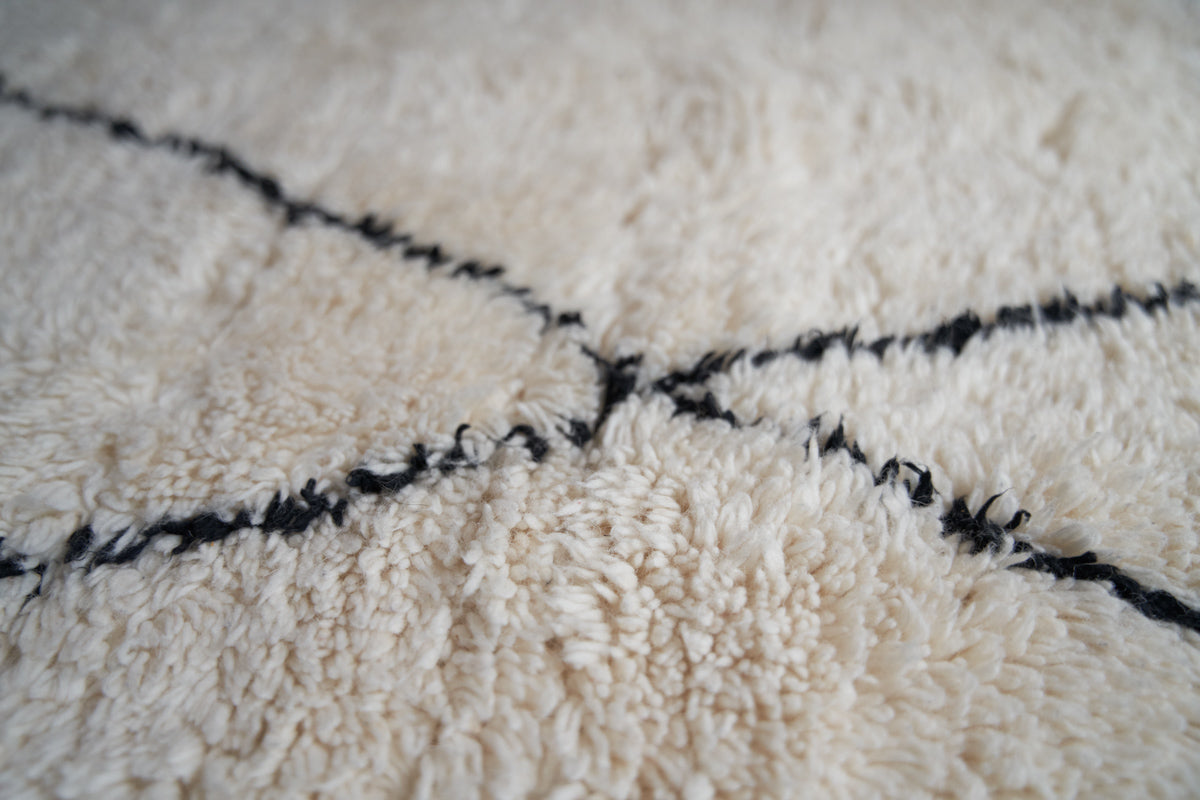 Primrose is a Beni Ourain rug with a geometric pattern, primarily beige in colour with black borders.