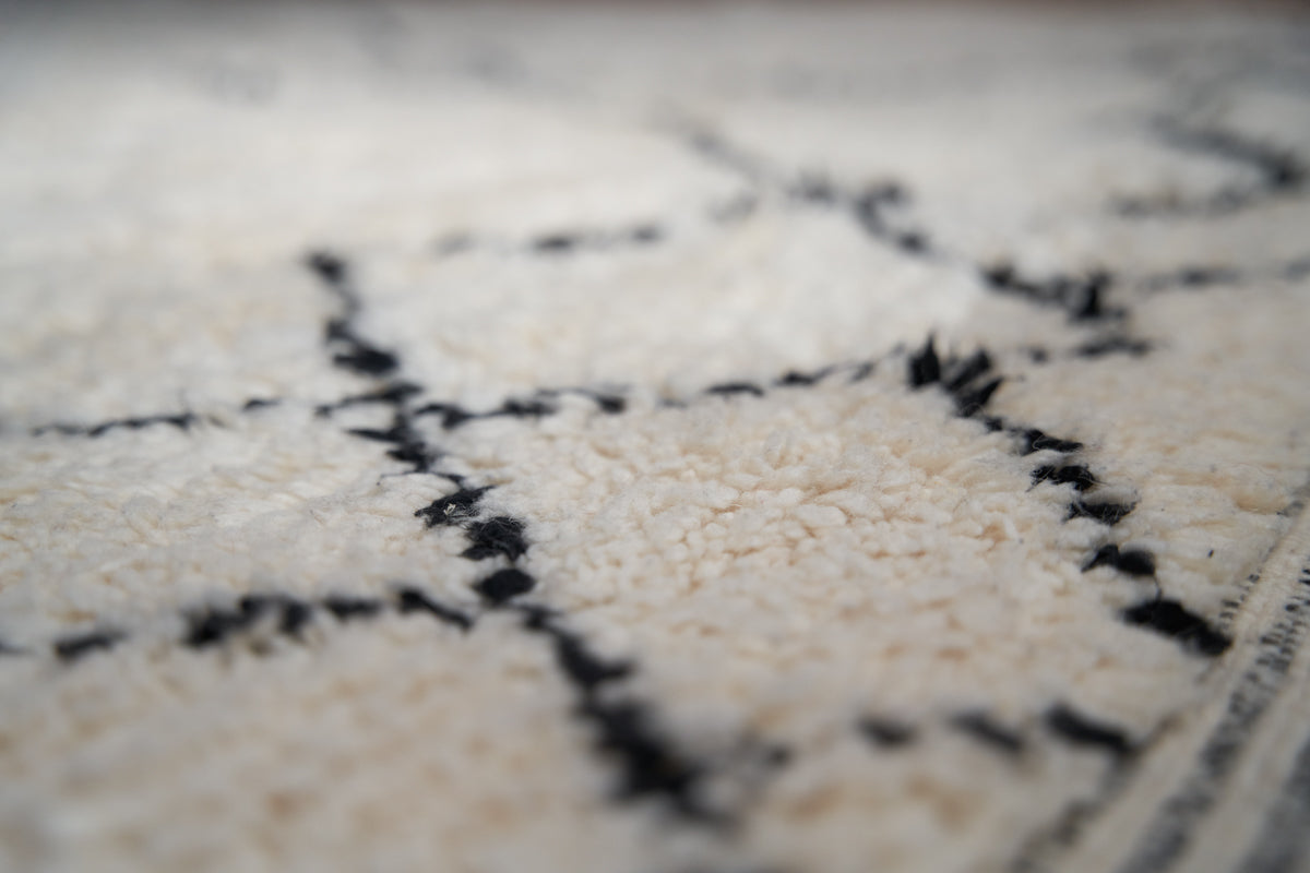 Primrose is a Beni Ourain rug with a geometric pattern, primarily beige in colour with black borders.