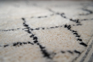 Primrose is a Beni Ourain rug with a geometric pattern, primarily beige in colour with black borders.