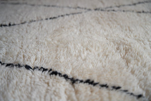 Primrose is a Beni Ourain rug with a geometric pattern, primarily beige in colour with black borders.