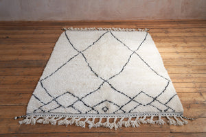 Primrose is a Beni Ourain rug with a geometric pattern, primarily beige in colour with black borders.