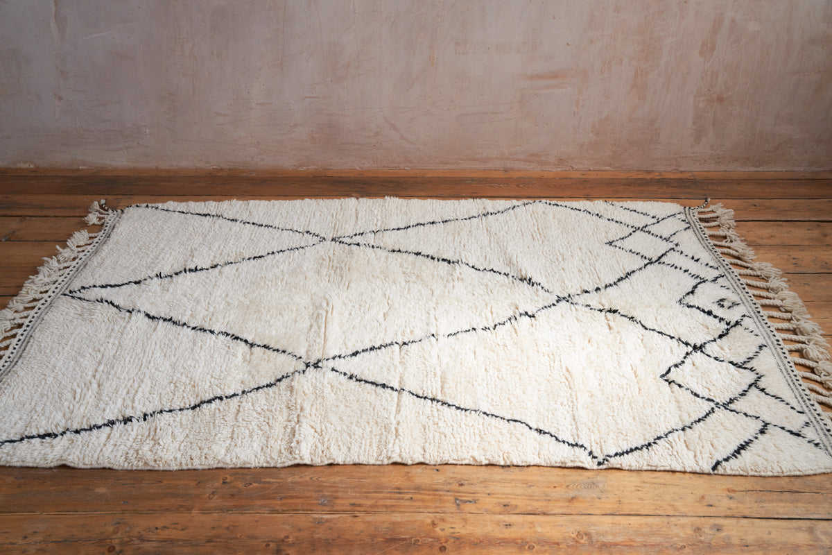 Primrose is a Beni Ourain rug with a geometric pattern, primarily beige in colour with black borders.