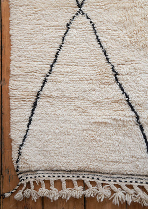 Primrose is a Beni Ourain rug with a geometric pattern, primarily beige in colour with black borders.