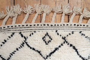 Primrose is a Beni Ourain rug with a geometric pattern, primarily beige in colour with black borders.