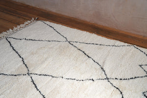 Primrose is a Beni Ourain rug with a geometric pattern, primarily beige in colour with black borders.