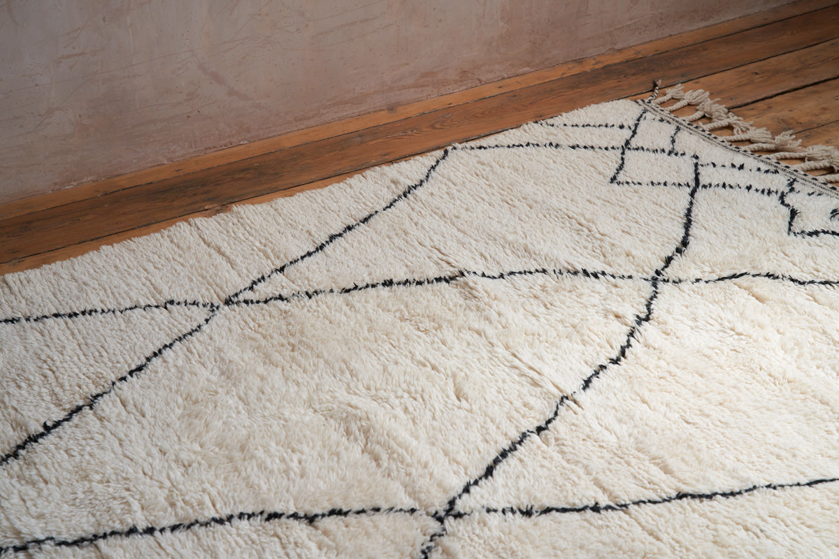 Primrose is a Beni Ourain rug with a geometric pattern, primarily beige in colour with black borders.