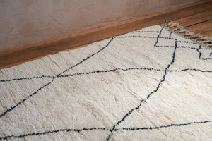 Primrose is a Beni Ourain rug with a geometric pattern, primarily beige in colour with black borders.